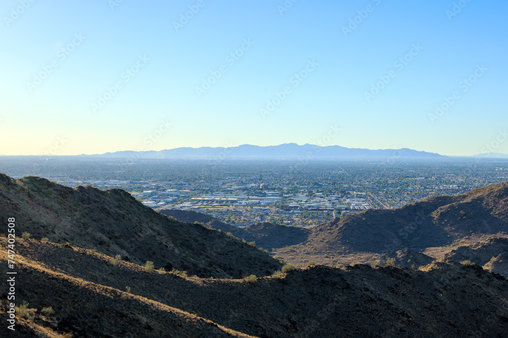 Naklejka premium Late afternoon in the west side of Valley of the Sun, view of Glendale, Peoria and Phoenix from North Mountain Park, Arizona, backlit shot