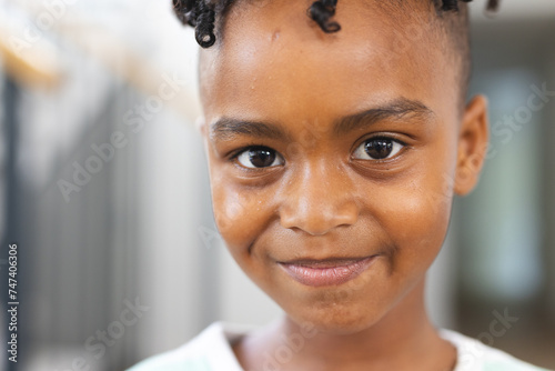 Close-up of a smiling African American boy with short curly hair