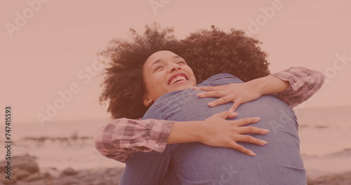 Happy african american couple hugging each other at the beach