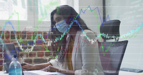 Image of financial data processing over businesswoman wearing face mask