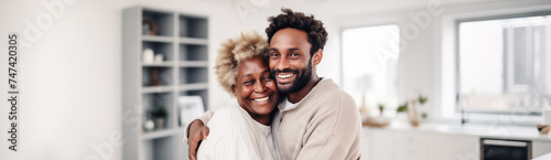 Joyful African American Mother and Son Embracing in Modern Kitchen