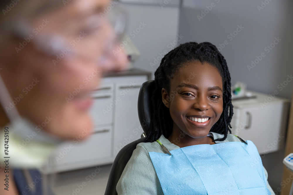 Multicultural lady in dental clinic doing teeth checkup Multicultural lady in dental clinic doing teeth checkup