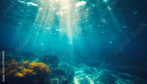 Underwater background with blue water and sun rays. Copy space © Marko