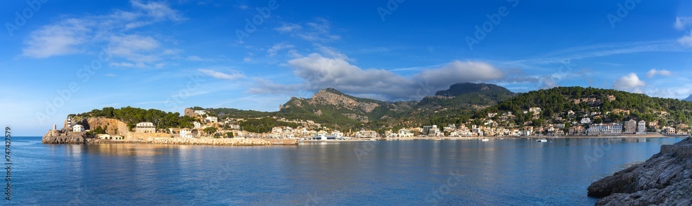 panorama view of the natural bay and harbour of Port de Soller in northern Mallorca in warm evening light