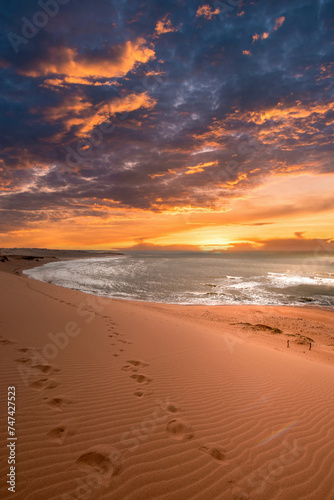 Beautiful landscape with orange sunset in the Taroa dunas and sea view. Guajira  Colombia. 