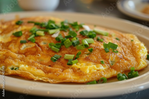 A plate of egg foo young, an omelette dish found in Chinese Indonesian, British, and Chinese American cuisine