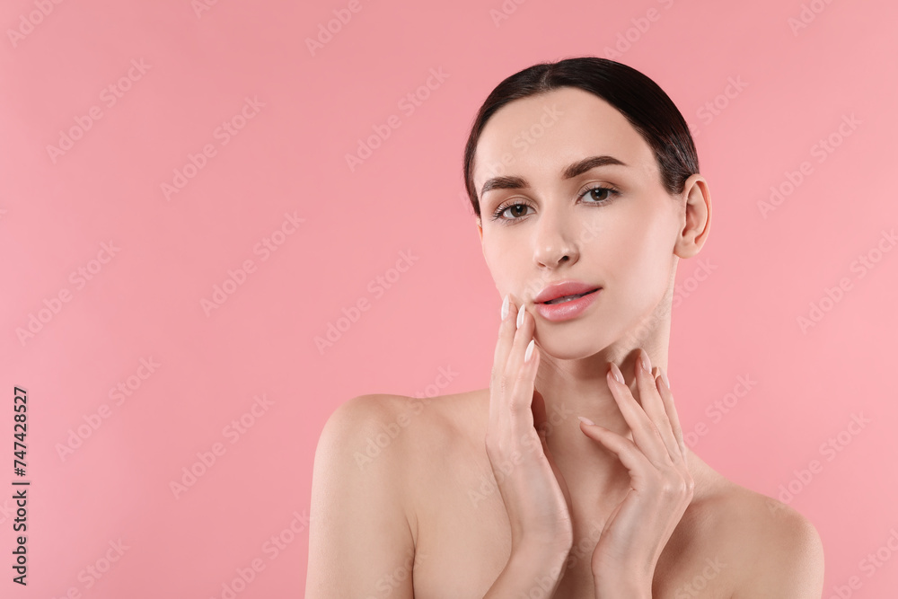 Portrait of beautiful young woman on pink background. Space for text