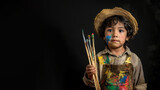 a studio portrait of little latin american boy dressed up as a artist isolated on black background