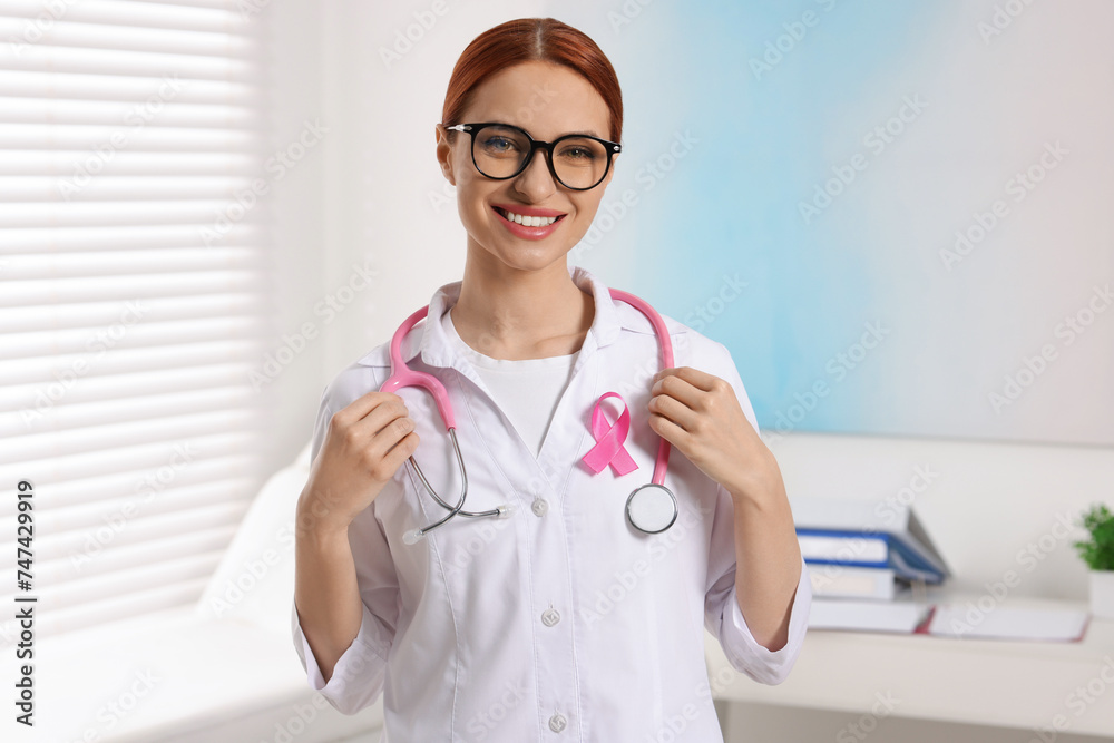 Mammologist with pink ribbon in hospital. Breast cancer awareness Mammologist with pink ribbon in hospital. Breast cancer awareness