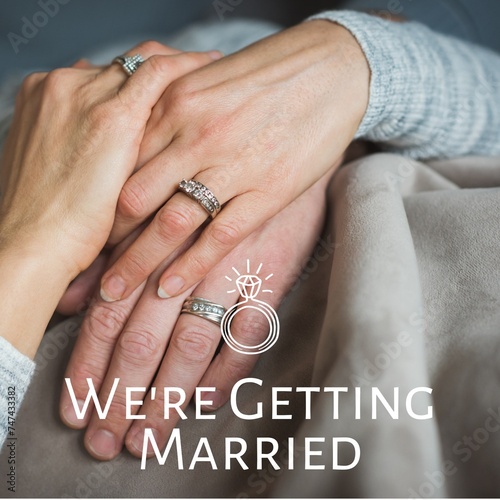 Celebrating love and commitment, the image showcases intertwined hands adorned with engagement rings