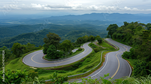 Winding Mountain Road Through Lush Greenery with Scenic Overlook.