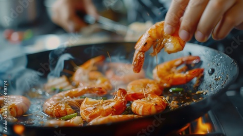Person cooking shrimp in a frying pan. Ideal for food and cooking concepts