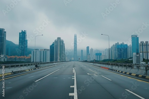 Busy highway with urban buildings in the background. Suitable for transportation and cityscape concepts