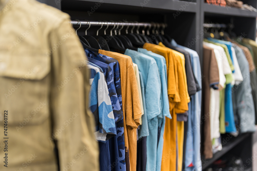 Assorted male clothing on shop rack Assorted male clothing on shop rack
