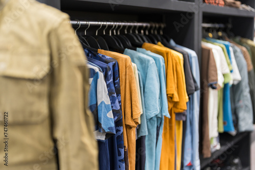 Assorted male clothing on shop rack