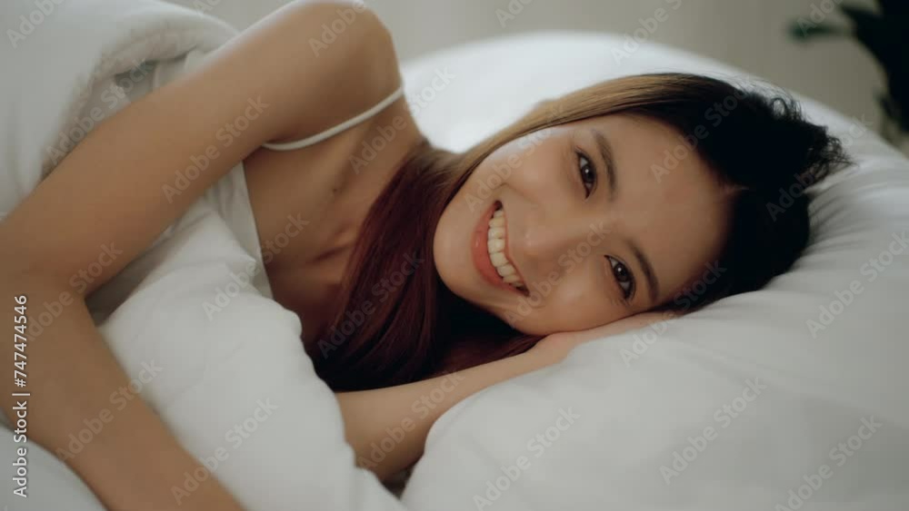 Wake up moment of Beautiful asian woman after have sweet dreams and deep sleep in bed comfortably with pillows. She sleeping on white bedding in light bedroom in morning. Have a good day. Wake up moment of Beautiful asian woman after have sweet dreams and deep sleep in bed comfortably with pillows. She sleeping on white bedding in light bedroom in morning. Have a good day.