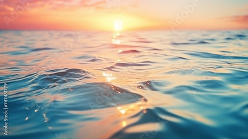 Abstract nature summer or spring ocean sea background. Small waves on water surface in motion blur with bokeh lights from sunrise