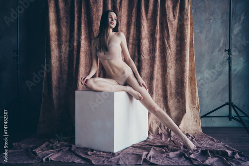 Photo no filter of stunning girl sitting white platform posing wear brand lingerie isolated studio background © deagreez