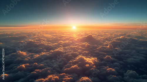 Sunrise above the clouds, where the warm sunlight breaks the horizon photo