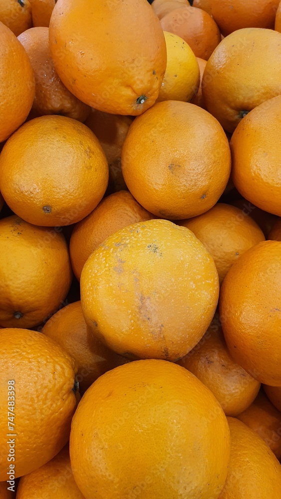 Close up pile of tasty fresh oranges sold at the market as a background. Close up pile of tasty fresh oranges sold at the market as a background.