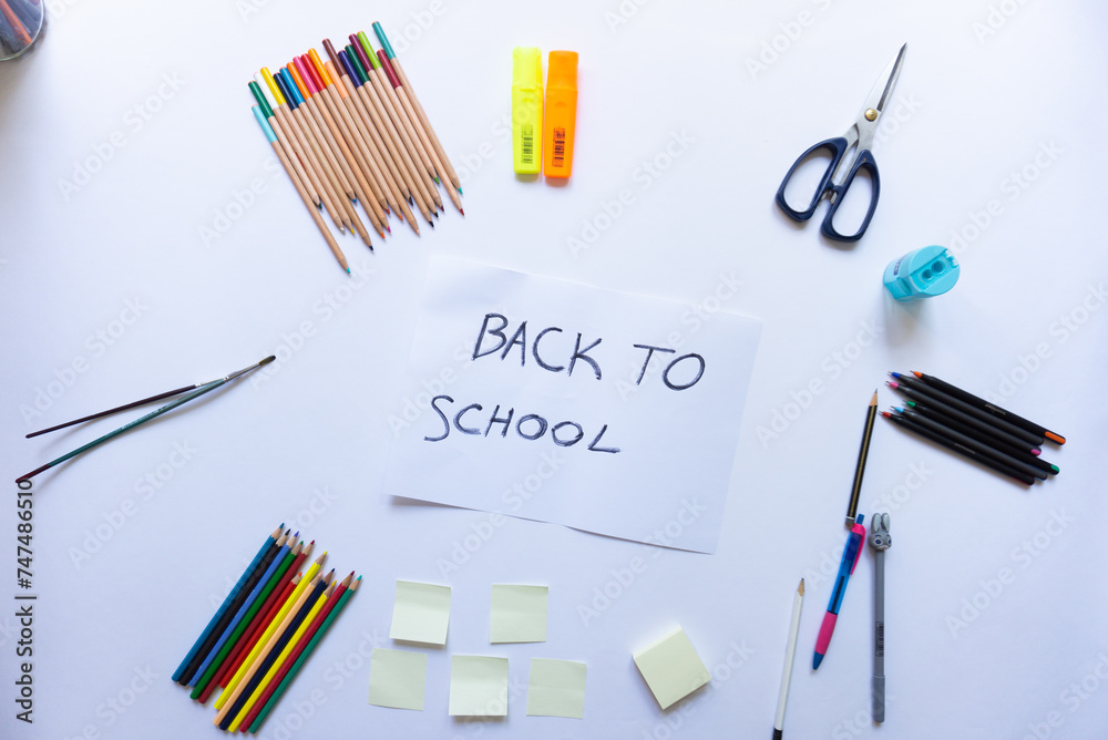School accessories on a white background and white paper in the middle with School accessories on a white background and white paper in the middle with