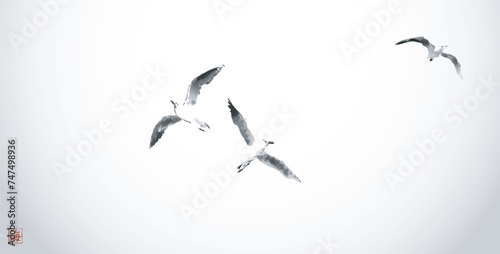Minimalistic ink painting, displaying a trio of seagulls in flight. Traditional oriental ink painting sumi-e, u-sin, go-hua. Hieroglyph - sea