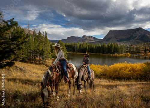 Cowboy cowgirl couple trail riding colorado wilderness autumn fall mountain  lake photo