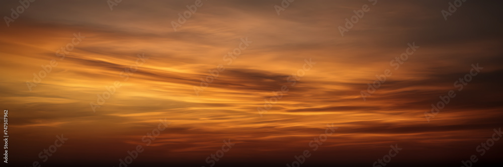 Photograph showcasing the dynamic interplay of golden and coppery smoke against a backdrop of twilight hues.