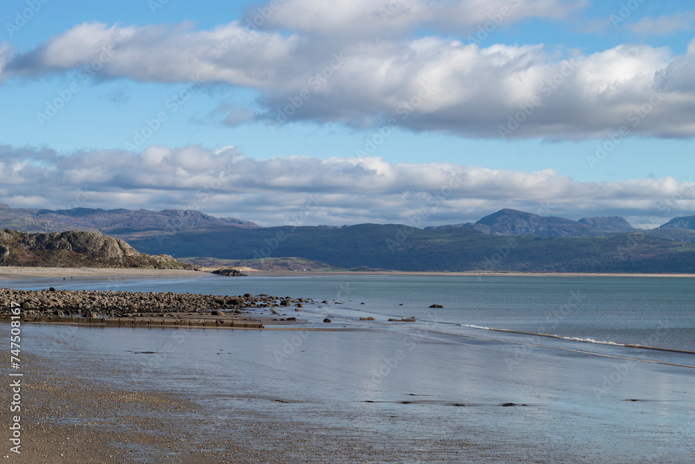 Beautiful Criccieth, Wales. View of the pristine beach at this small Welsh seaside resort at charming Llyn Peninsula. Winter landscape. View over Cardigan Bay to Black Rock sands and Snowdonia. Beautiful Criccieth, Wales. View of the pristine beach at this small Welsh seaside resort at charming Llyn Peninsula. Winter landscape. View over Cardigan Bay to Black Rock sands and Snowdonia.