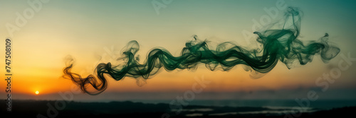 Photograph capturing the ethereal beauty of smoke tendrils in hues of emerald and jade against a backdrop of golden twilight.
