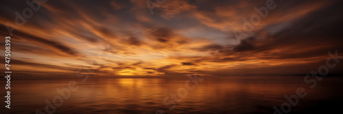 Photograph showcasing the dynamic interplay of golden and coppery smoke against a backdrop of twilight hues.