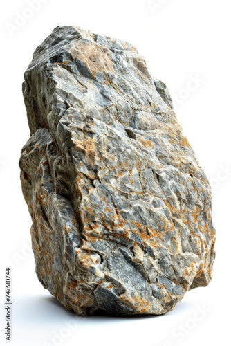 A large rock sitting on a white surface. Perfect for backgrounds