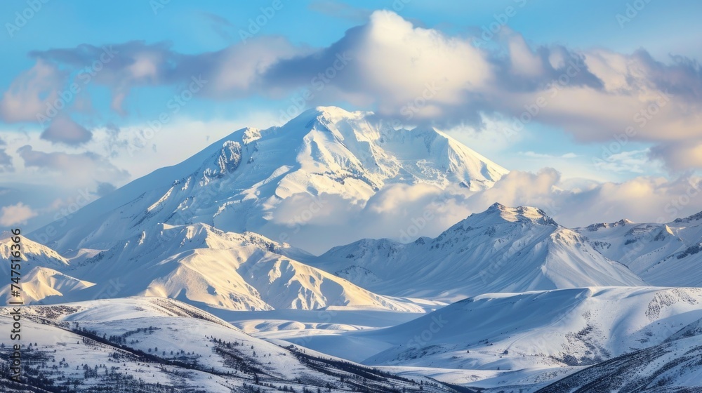 A majestic snow-covered mountain with dramatic clouds in the sky. Perfect for outdoor and nature-themed designs