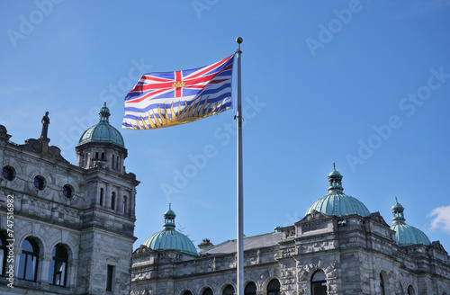 Flag of British Columbia waving in front of the Legislative Assembly of British Columbia Parliament Building in Victoria on Vancouver Island in Canada