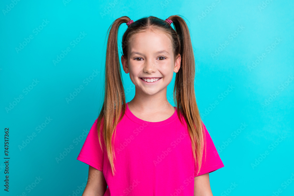 Photo of pretty lovely girl dressed pink clothes isolated on cyan color background Photo of pretty lovely girl dressed pink clothes isolated on cyan color background