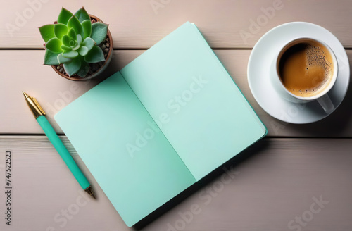 Elegant workspace with top view featuring a graceful arrangement. A coffee cup  empty notebook  pen  and a lush plant in a pot adorn the desk  creating a serene and atmosphere. Mint green color scheme