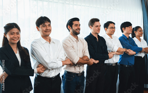 Business team standing, join and link hand together in line symbolize successful business partnership and professional synergy with diverse culture group people cooperation. Prudent