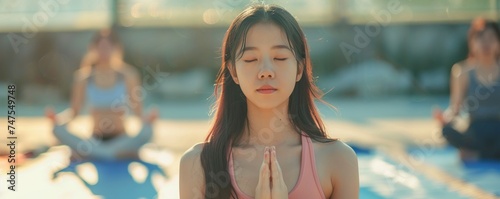 Attractive young Asian woman group exercising and sitting in yoga lotus position in yoga classes Breath control with copy space