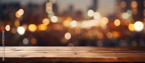 A wooden table is shown with a blurred background of city lights, possibly from a coffee shop or restaurant. The lights create a soft glow against the dark backdrop.
