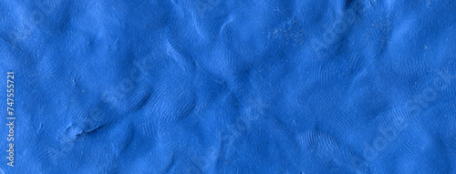 Ultramarine raw plasticine texture. Cobalt blue rough playdough textured background. Abstract modelling clay backdrop. Web banner, poster design or label design elements.
