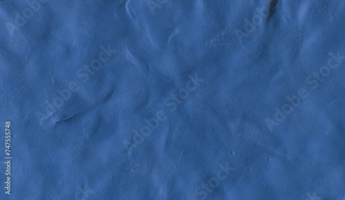 Raw plasticine texture. Ink blue rough playdough textured background. Abstract modelling clay backdrop. Web banner, poster design or label design elements.