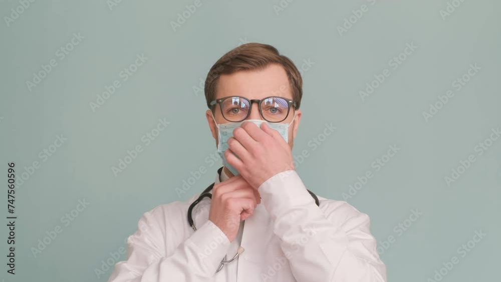 Doctor with eyewear smiles, wearing mask, glasses, and a white sleeve Doctor with eyewear smiles, wearing mask, glasses, and a white sleeve