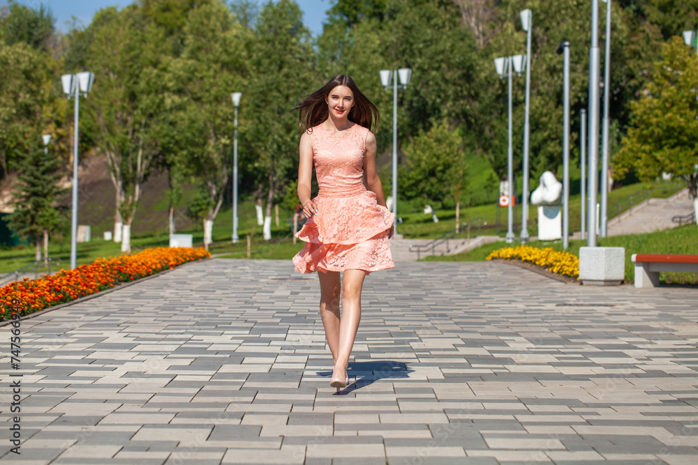 Full body portrait of a young beautiful brunette girl in a pink summer dress Full body portrait of a young beautiful brunette girl in a pink summer dress