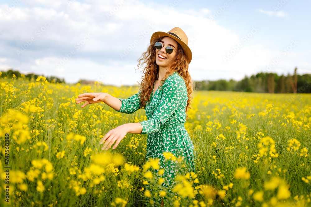 Happy woman enjoying nature on the field. Nature, vacation, relax and lifestyle. Summer landscape. Happy woman enjoying nature on the field. Nature, vacation, relax and lifestyle. Summer landscape.