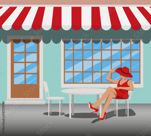 beautiful slender woman in a red dress and hat sits on a chair in a summer cafe