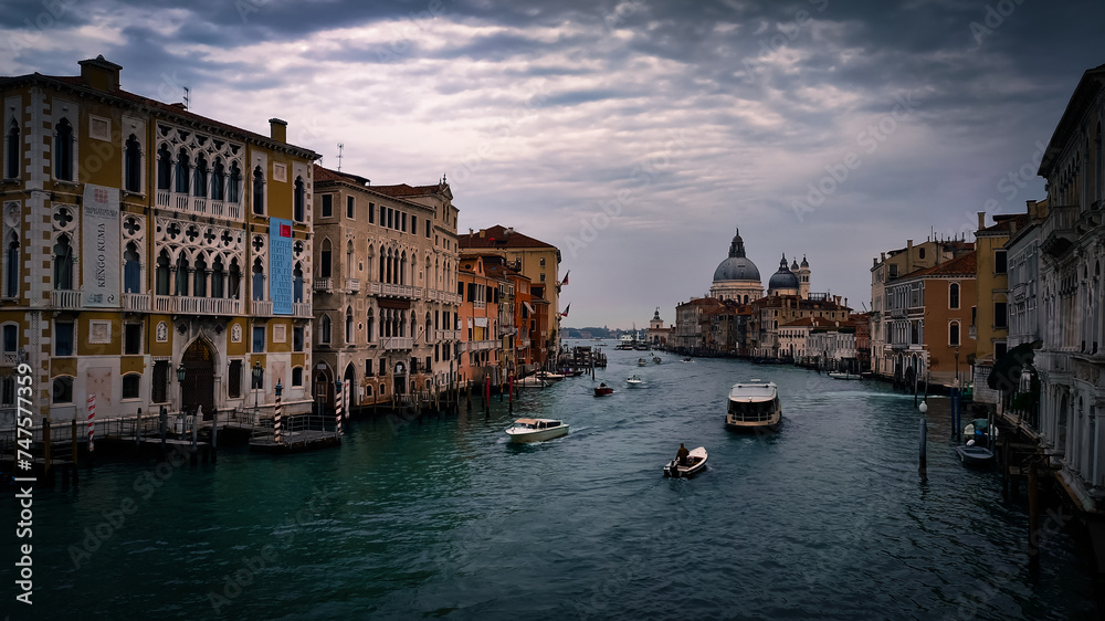 An atmospheric capture of Venice's iconic Grand Canal featuring traditional buildings and boats