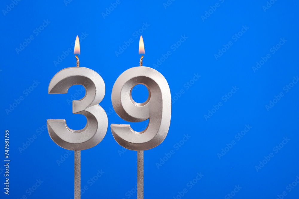 Birthday number 39 - Candle lit on blue background