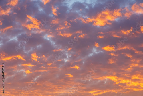 Abstract sunset clouds and sky nature background featuring vibrant colorful clouds at dusk © Michael Carni