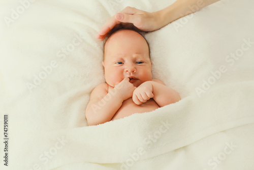Portrait of infant sweet sleeping lying on white bed at home