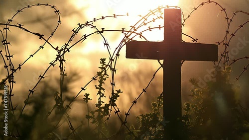 Cross and barbed wire fence, concept of war losses and war cessation. photo